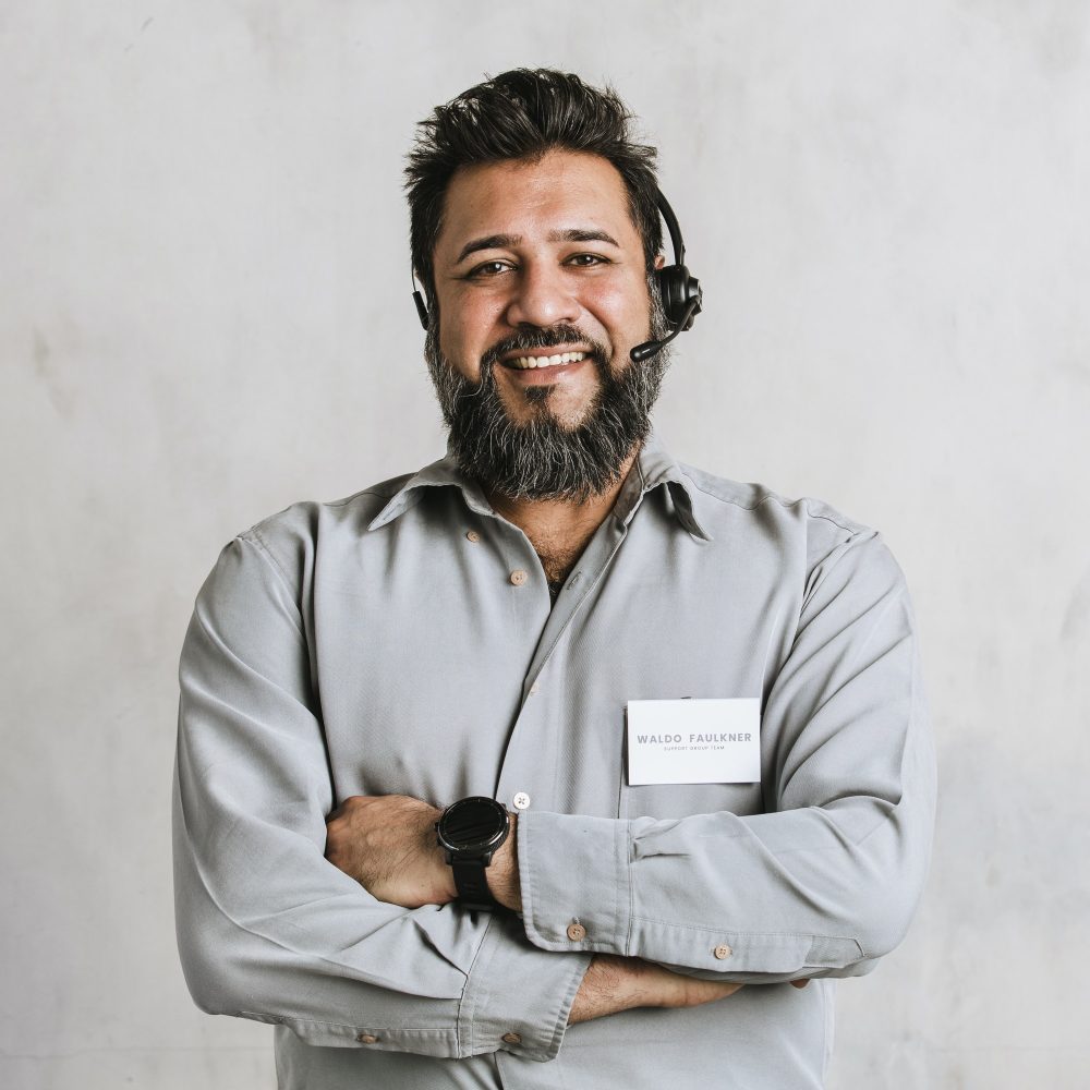 indian operator assistant using a microphone headset while conversing with a customer.jpg